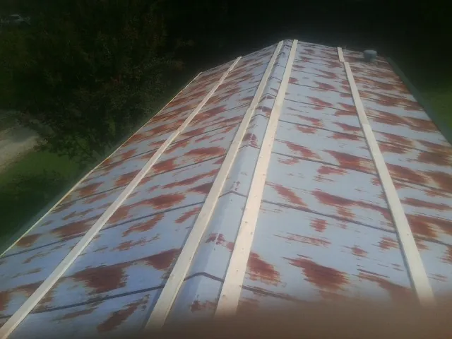 Rusted metal roof panels with new wood purlins before replacement — Storm Damage Roof Repair in Camp Hill by Roofing Brothers
