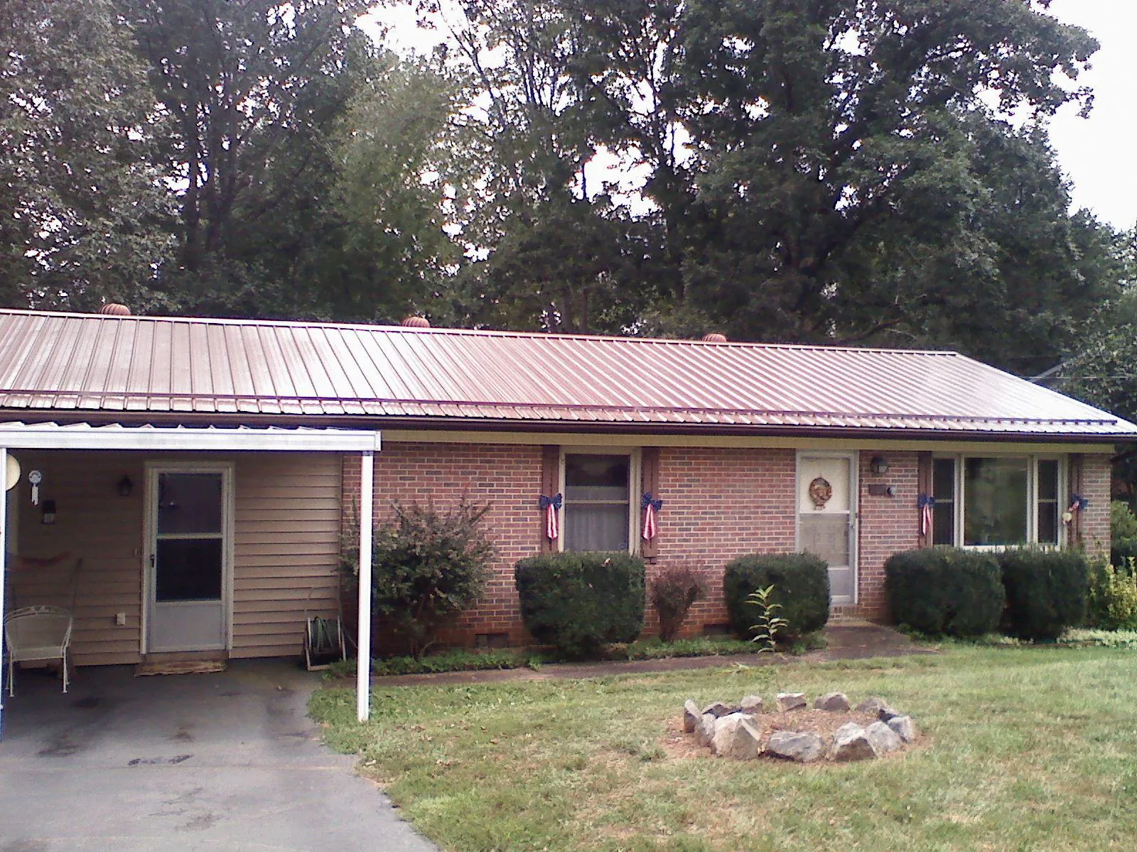 Bronze metal roof and carport on a brick ranch home — Roof Repair work by our crew in Camp Hill