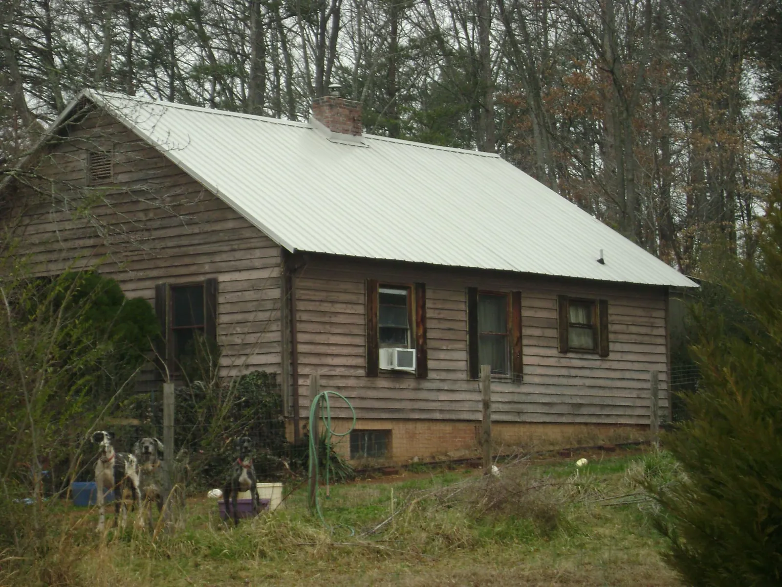 White metal roof on an old wood sided farmhouse, from a Asphalt Shingle Roof Repair job in Camp Hill